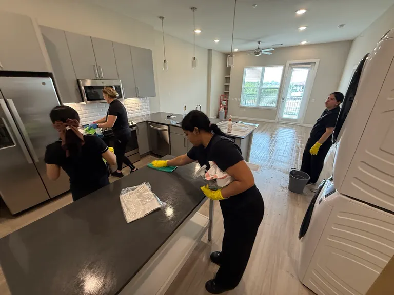 The Reina's Cleaning team cleaning an open-plan kitchen together